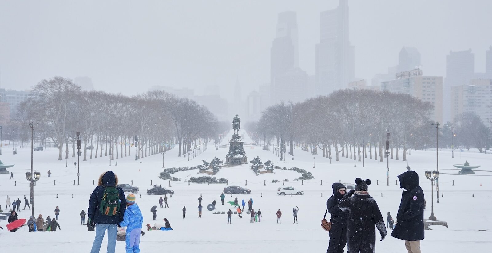 People gather at Philadelphia Art Museum steps during a winter storm in Philadelphia, Sunday, Jan. 25, 2026.