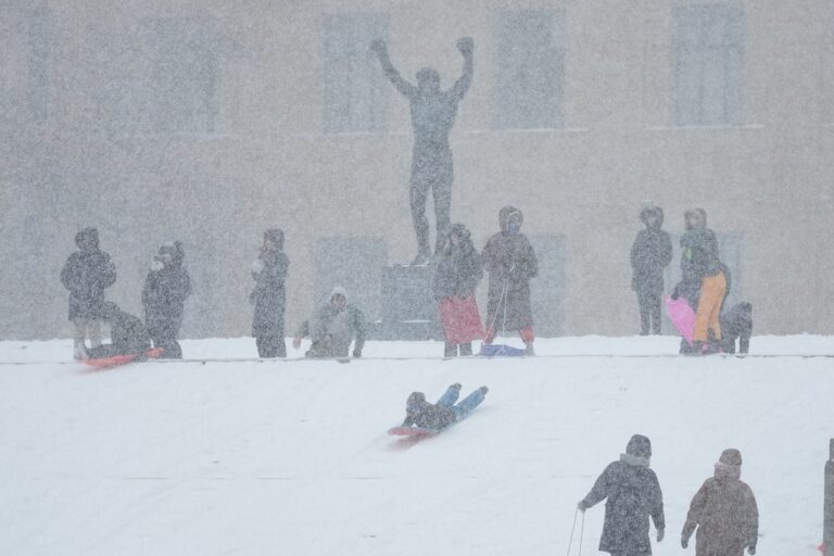People sled on Philadelphia Art Museum steps by the Rocky statue during a winter storm in Philadelphia, Sunday, Jan. 25, 2026.