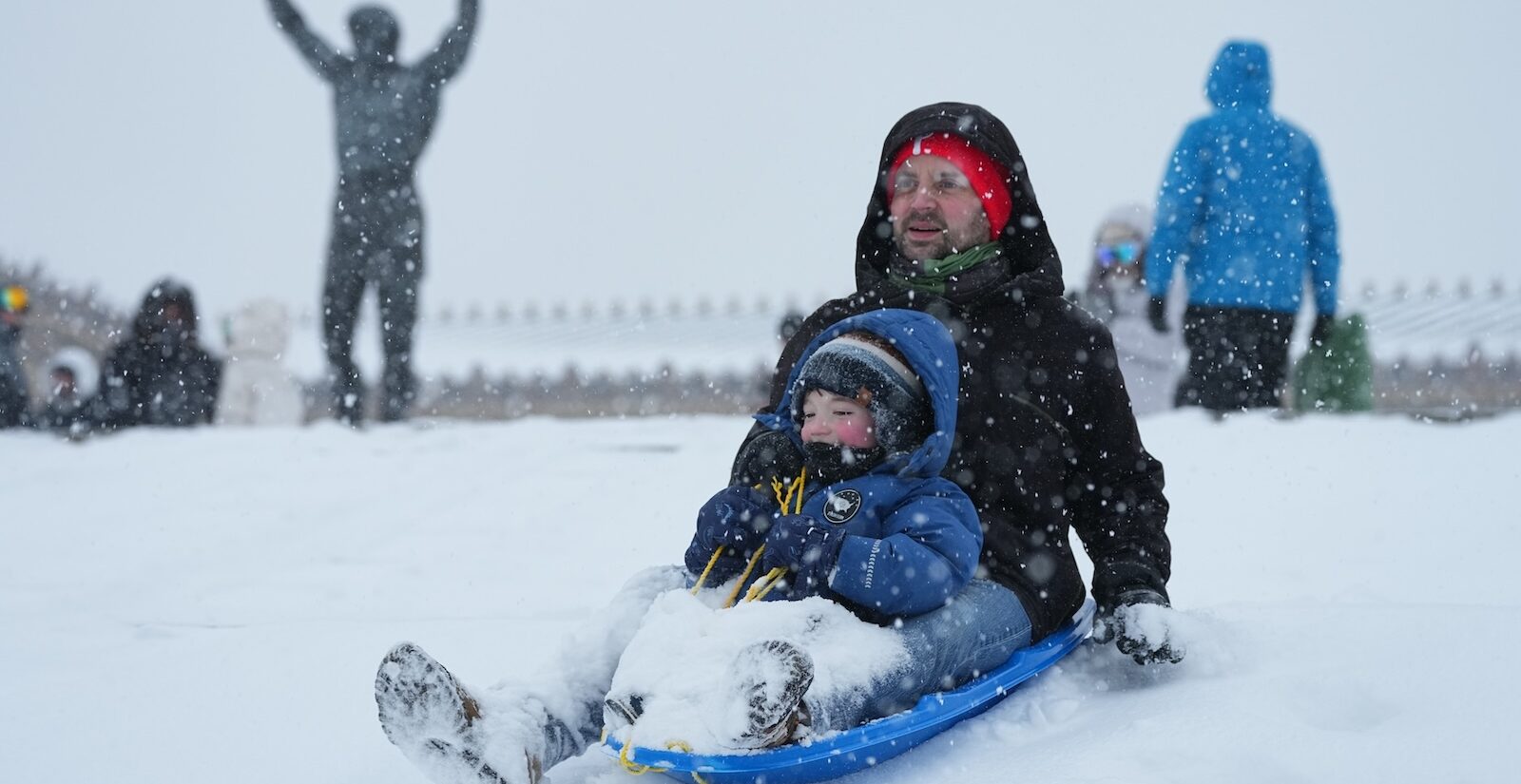 People sled on Philadelphia Art Museum steps by the Rocky statue during a winter storm in Philadelphia, Sunday, Jan. 25, 2026.