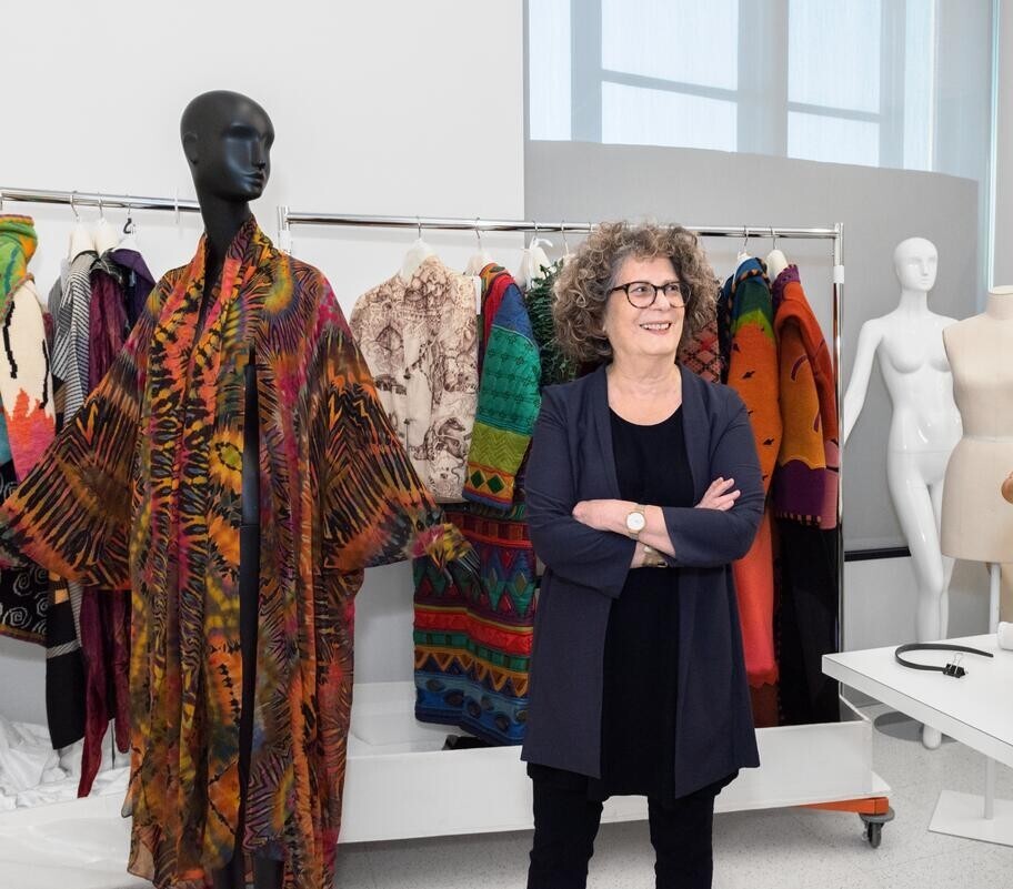 Dylis Blum, the former curator of fashion at the Philadelphia Art Museum, stands next to a mannequin wearing a colorful piece