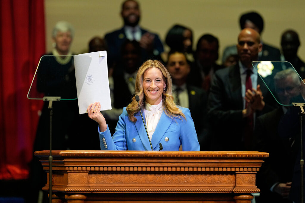 New Jersey Governor New Jersey Gov. Mikie Sherrill holds up a just signed executive order