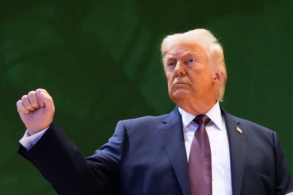 Switzerland Davos Trump US President Donald Trump holds up a fist