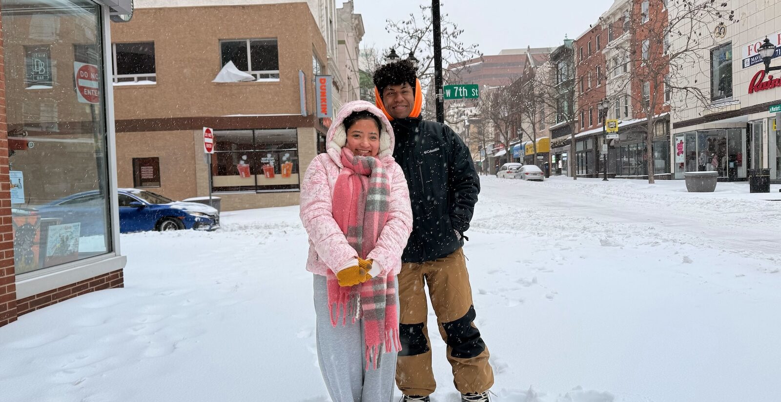 Arbee Catipay and Cortez Warren pose for a photo on a snowy Wilmington, Delaware street