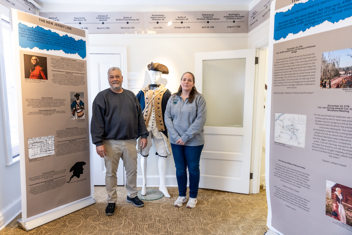 Marisa Bozarth, museum curator of history for Burlington County (right), and Eric Orange, museum attendant for Burlington County inside the Burlington County Joins the Revolution exhibit in the Warden’s House Gallery in Mt. Holly, N.J.