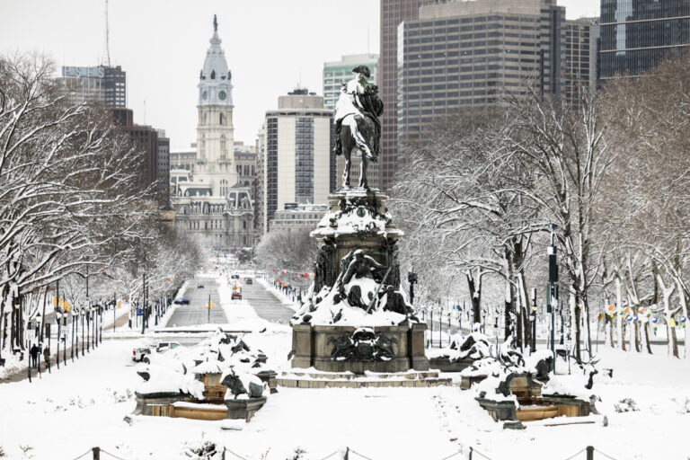 A view down the Benjamin Franklin Parkway toward Philadelphia City Hall covered in snow
