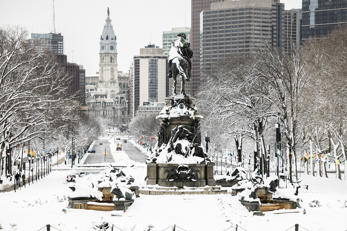 A view down the Benjamin Franklin Parkway toward Philadelphia City Hall covered in snow