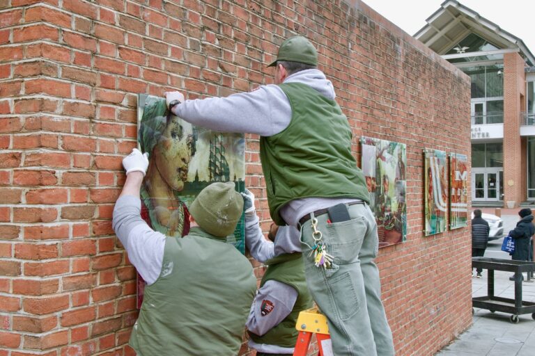 Workers are hanging the panels back up on the wall