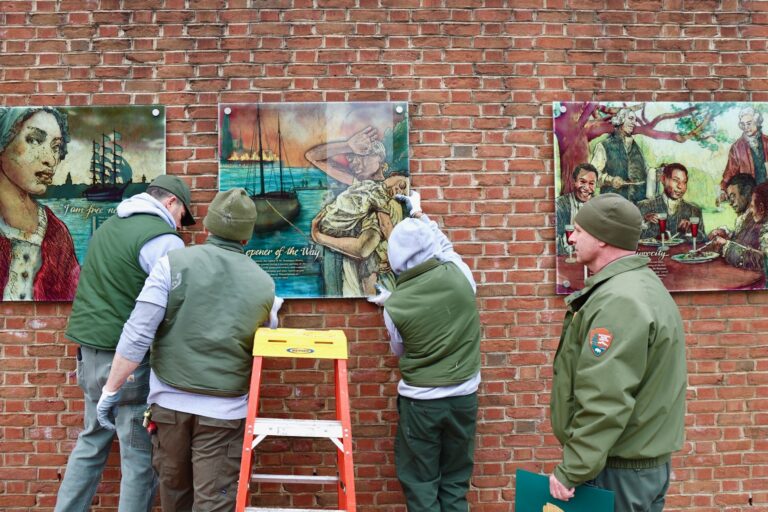 Workers are hanging the panels back up on the wall