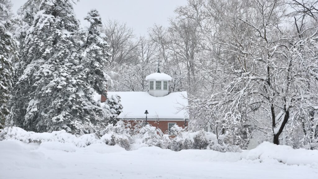 2026 02 23-e lee-moorestown nj-blizzard aftermath cupola Snow blankets the yard, trees, and roof of a school building in Moorestown, New Jersey