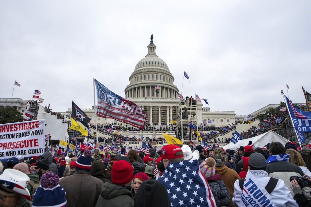 January 6 Then and Now Photo Gallery Supporters of President Donald Trump rally at the U.S. Capitol on Jan. 6, 2021, in Washington. As a winter storm bore down on the nation's capital four years later, lawmakers would again gather at the U.S. Capitol, this time without protests, challenges or violence — but behind layers of black security fencing serving — to certify Trump's 2024 win over Vice President Kamala Harris. (AP Photo/Jose Luis Magana)