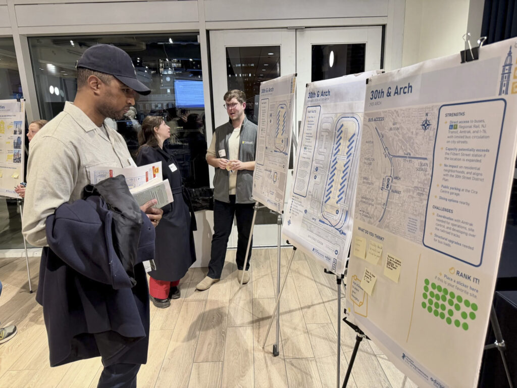 IMG_0312-scaled Walt Walker, an environmental engineer who lives in West Philly, checks out posters at an open house on the future of the city's intercity bus station