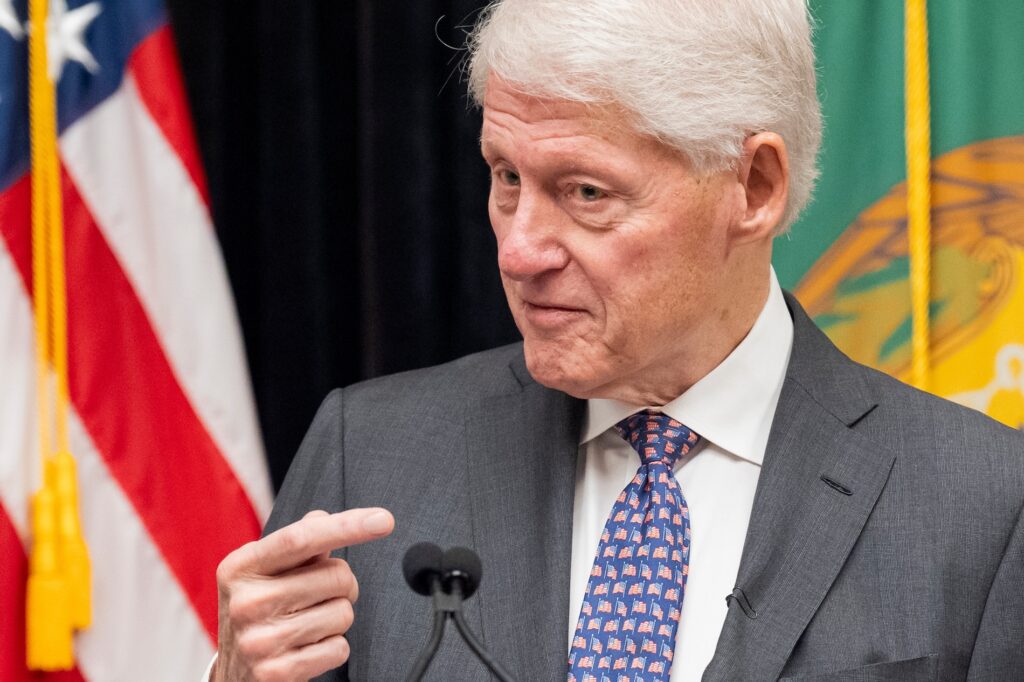 Bill Clinton speaking into a microphone