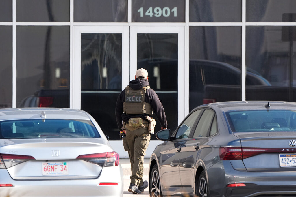 Immigration Detention An ICE agent stands outside a warehouse