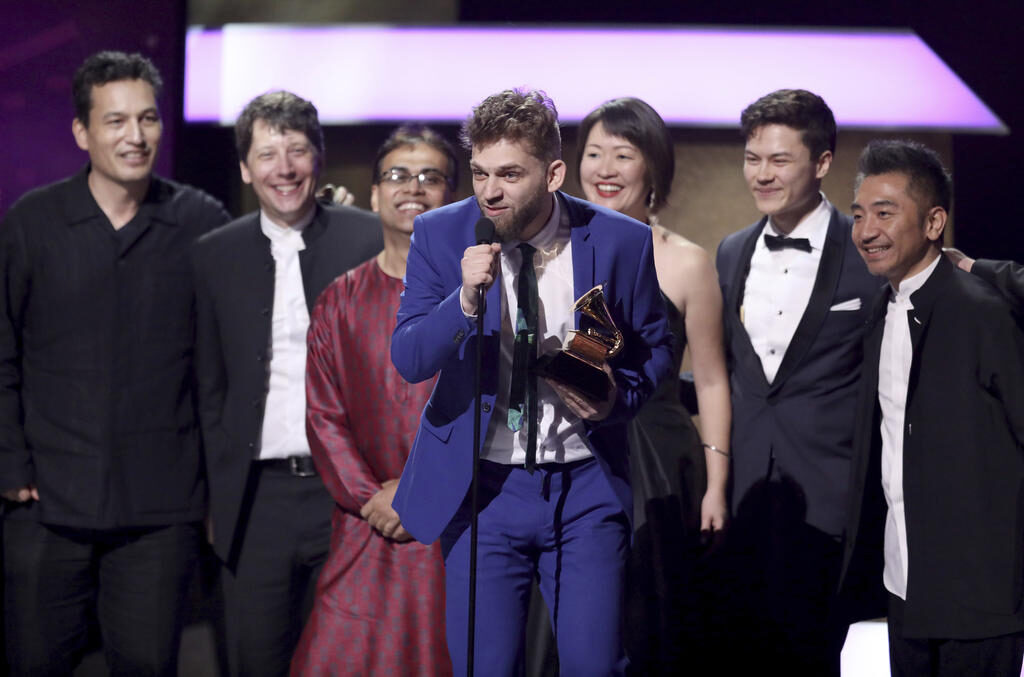 Johnny Gandelsman, and members of the Silk Road Ensemble, accept the award for best world music album for "Sing Me Home" at the 59th annual Grammy Awards
