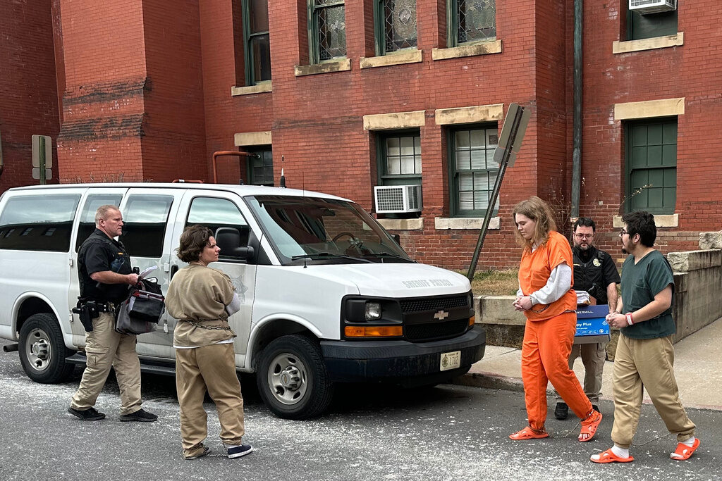 Maryland Zizians Deputies escort Michelle Zajko, left, Daniel Blank, right, and Jack LaSota, in orange, from the Allegany County Courthouse