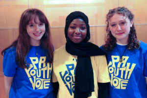 Three teenage girls posing for a photo in their PA YOUTH VOTE volunteer t-shirts