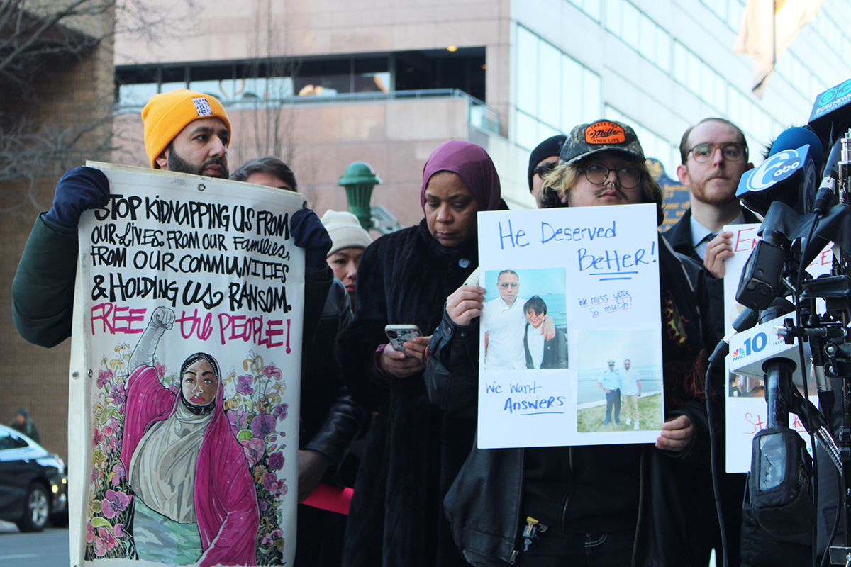 Several people holding up signs protesting the death of Parady La