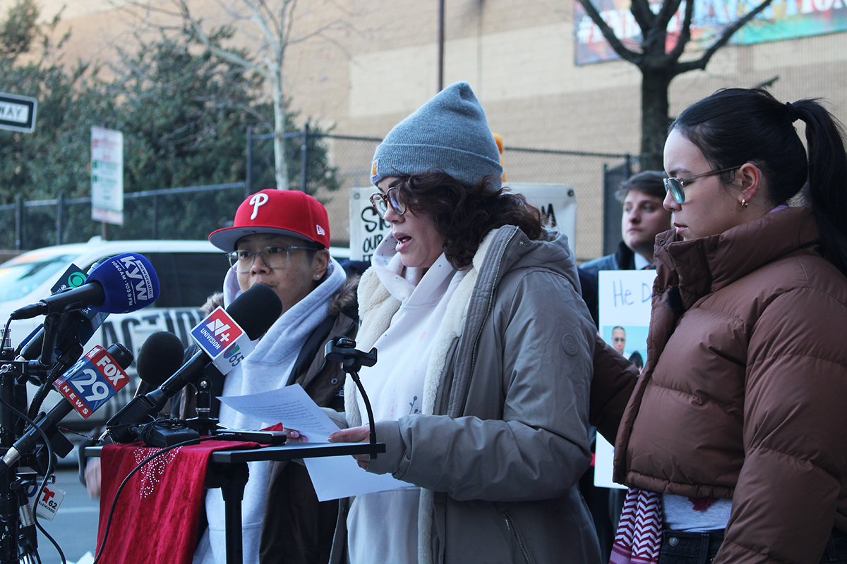 Three women speak at a podium at a press conference outside