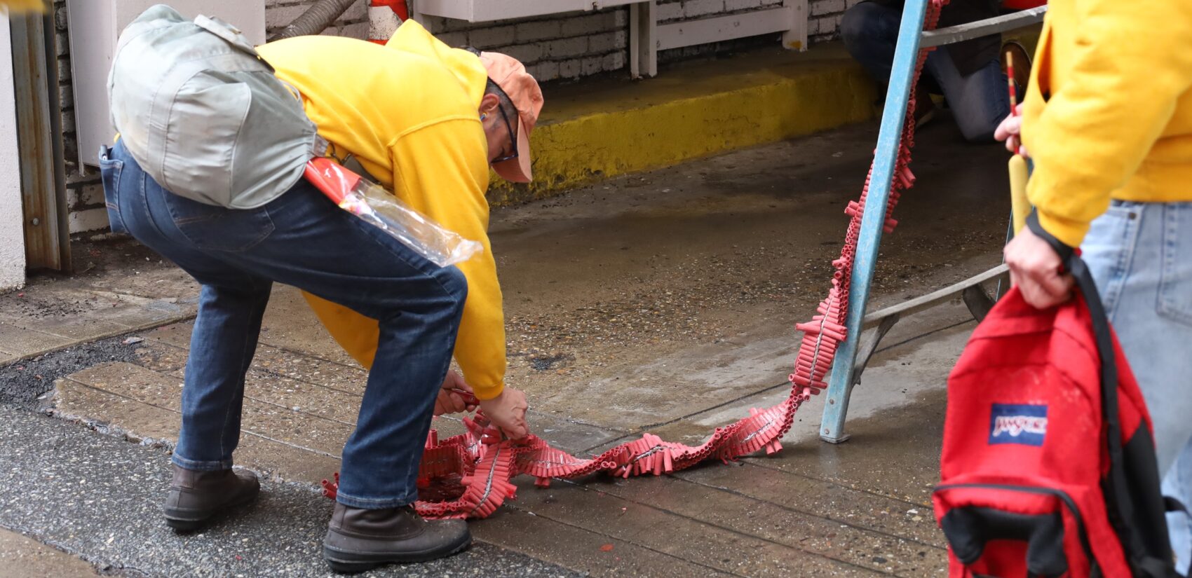 A person unrolling firecrackers