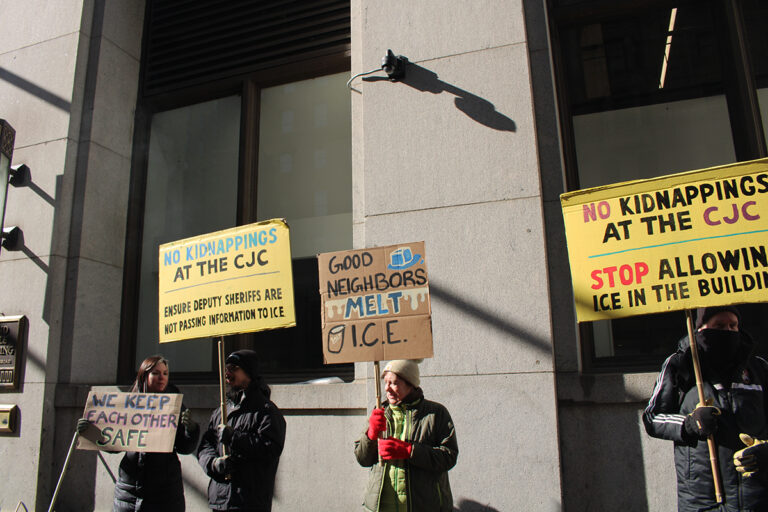 Protesters hold up handmade signs outside the Criminal Justice Center