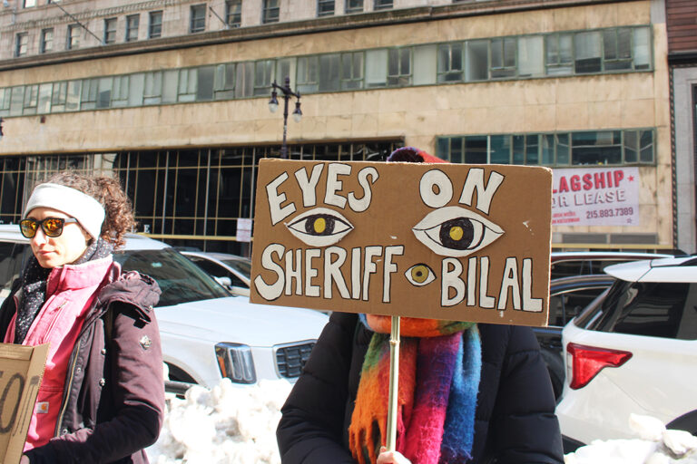Protesters hold up handmade signs outside the Criminal Justice Center