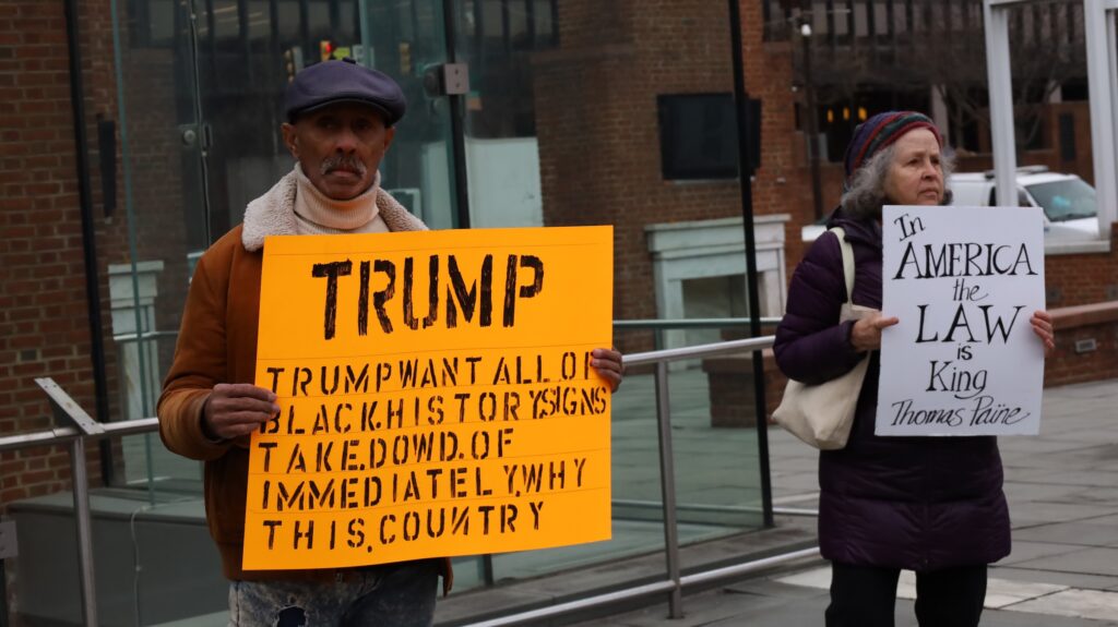 People holding up signs at the rally