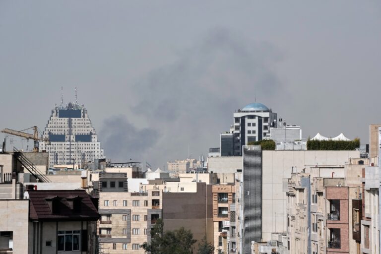 Smoke can be seen in the background of the downtown skyline in Tehran after an explosion