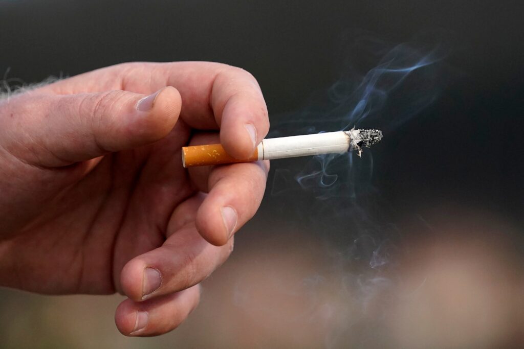 tobacco-cigarette-file-ap a lit cigarette in a hand