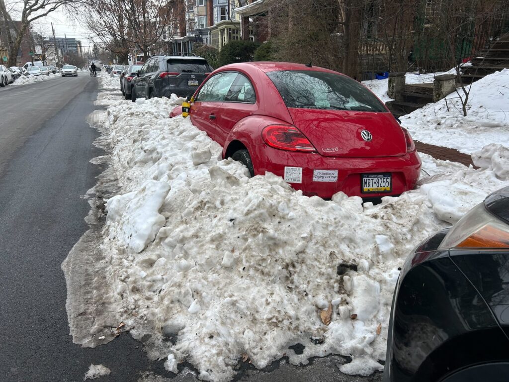 A car in West Philadelphia remains snowed in Friday