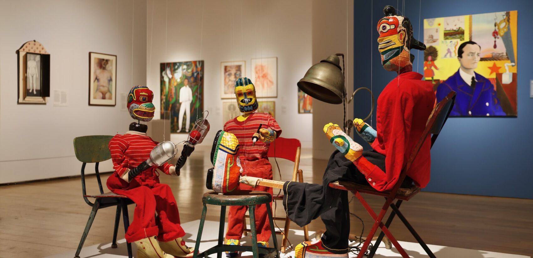 A grouping of papier-mâché marionettes by Karl Wirsum