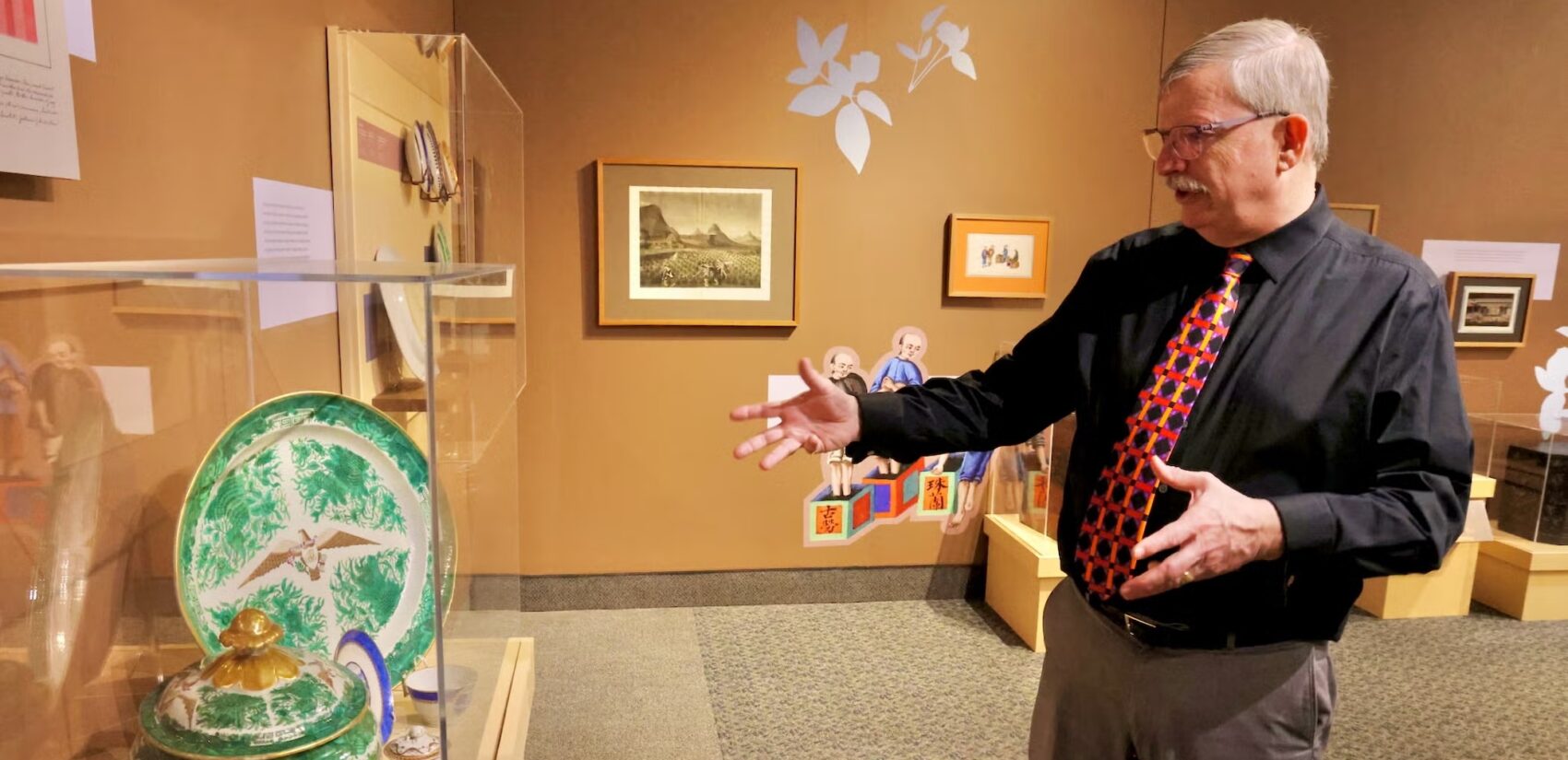 Peter Seibert pointing at a display case.
