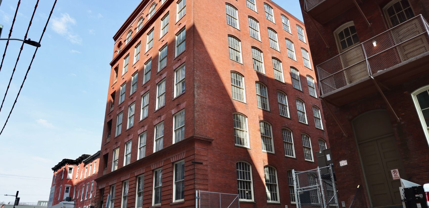 The exterior of a large brick building is shown.