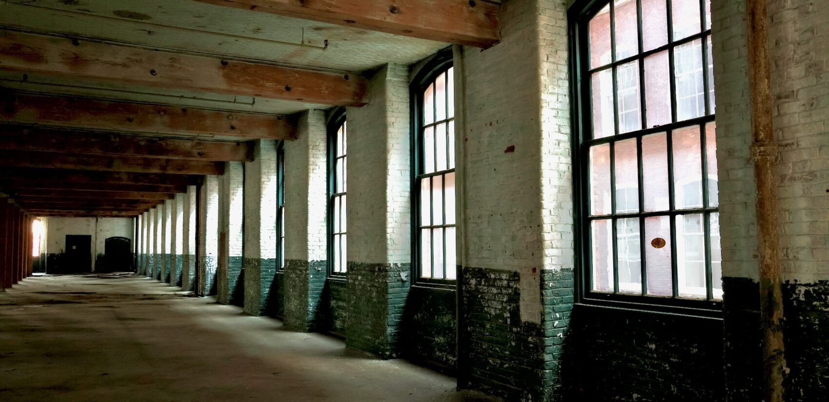 Inside an empty floor of the building, showing the high ceilings and windows.