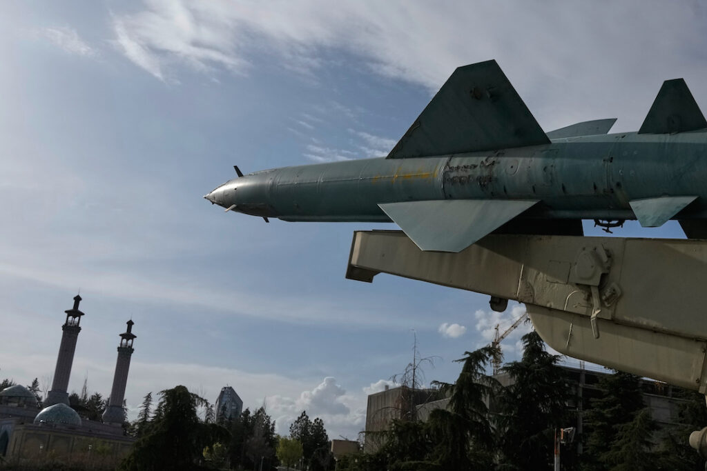 Iran War A missile is displayed in a permanent exhibition at a recreational area as minarets of a mosque are seen at rear, in northern Tehran, Iran, Tuesday, March 24, 2026. (AP Photo/Vahid Salemi)