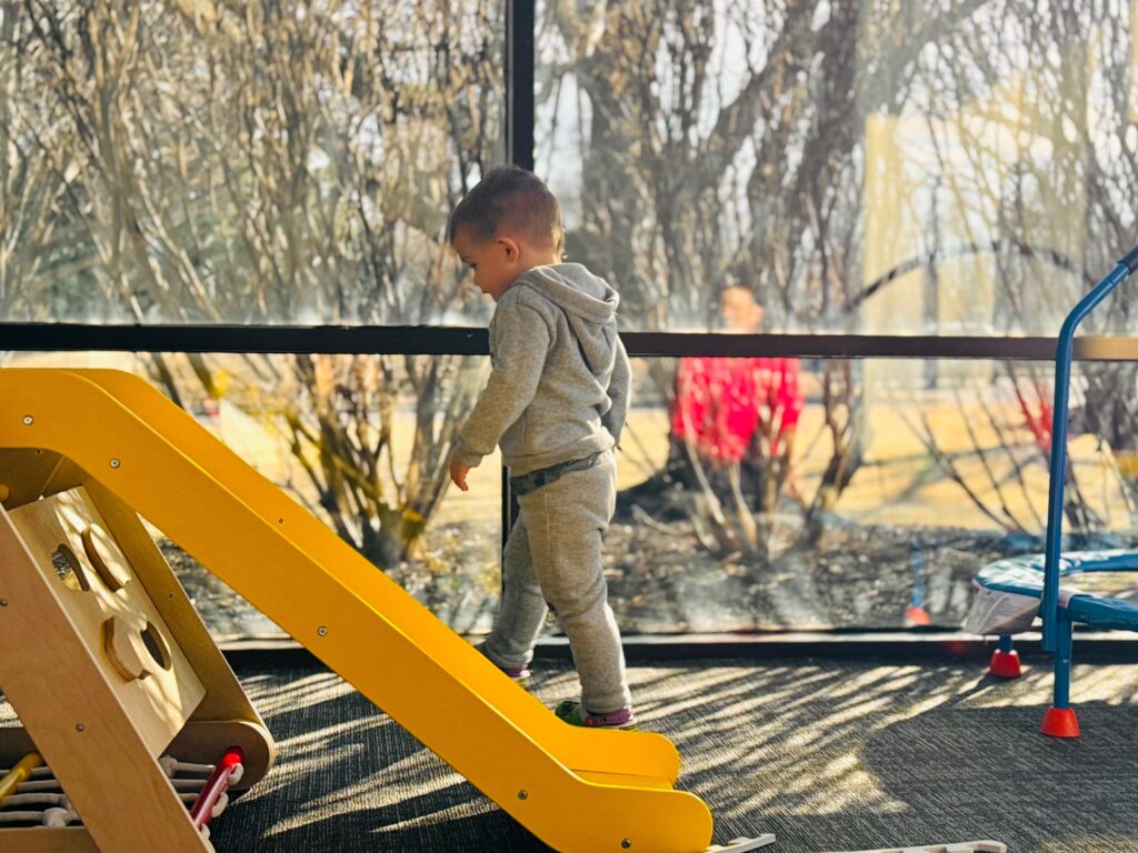 CHOP-Soar-autism-partnership-4-file a child walks up a slide