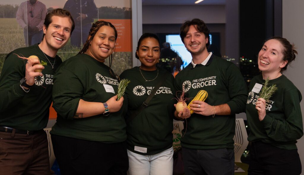 community-grocer-2026-03-27-2 5 people posing for a photo together.