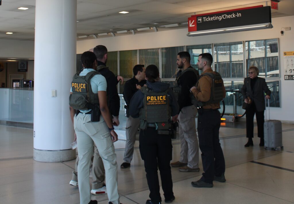 ice-philadelphia-airport-en-032426-4 ICE agents standing and talking at the Philadelphia airport.