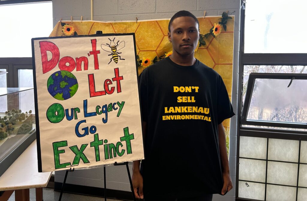 lankenau-school-closure-protest-philadelphia-1 Messiah Stokes next to a sign reading Don't Let Our Legacy Go Extinct
