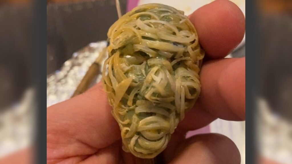 nail-trophy-face-bp-032726 Working with nail clippings to create a replica of the FIFA World Cup trophy