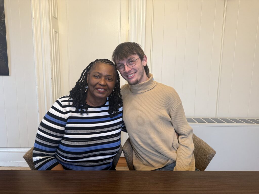 Ms. Julia and Jackson Tignor posing for a photo together while sitting next to each other at a table.