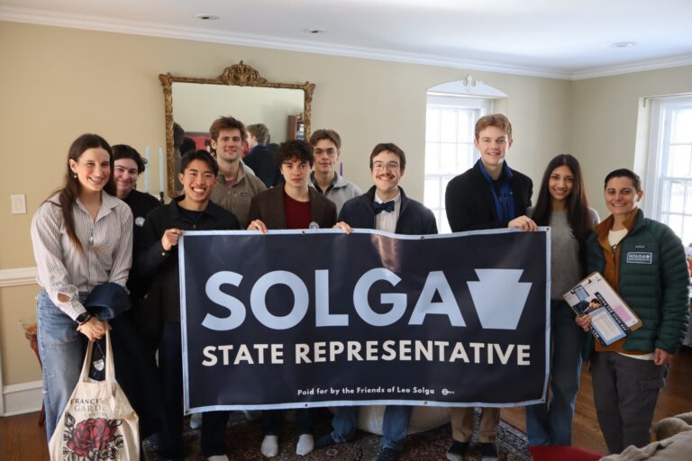 Leo Solga and supporters holding up a large campaign poster