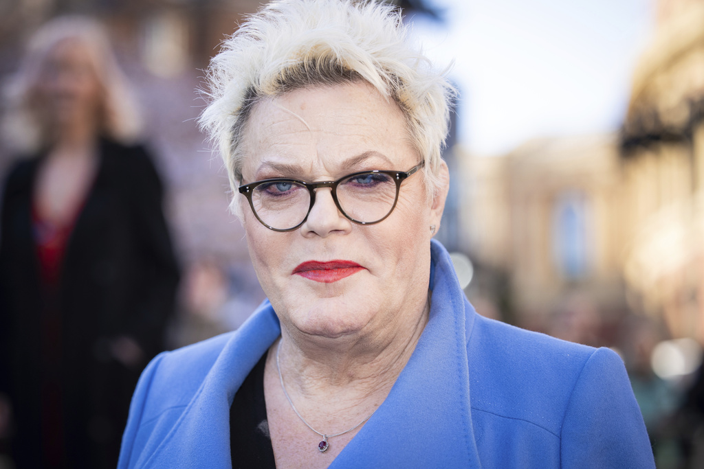 Suzy Eddie Izzard poses for photographers upon arrival at the Olivier Awards