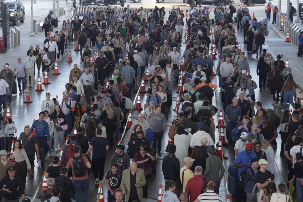 Travel Delays Travelers line up at a TSA checkpoint at George Bush Intercontinental Airport in Houston, Thursday, March 26, 2026.