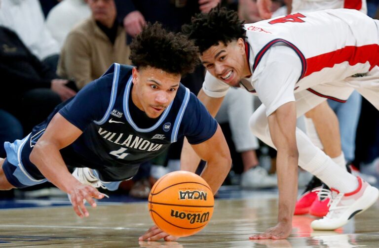 Villanova guard Tyler Perkins dives for a basketball