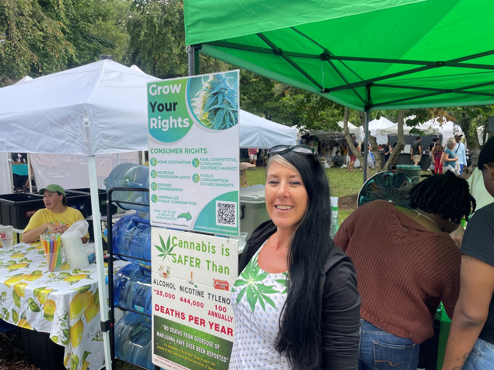 Zoe Patchel posing for a photo in front of an information booth