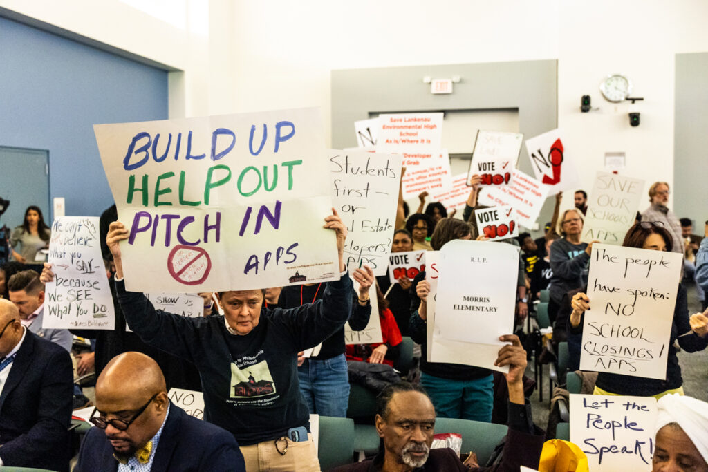 Protesters holding up signs to disrupt the vote