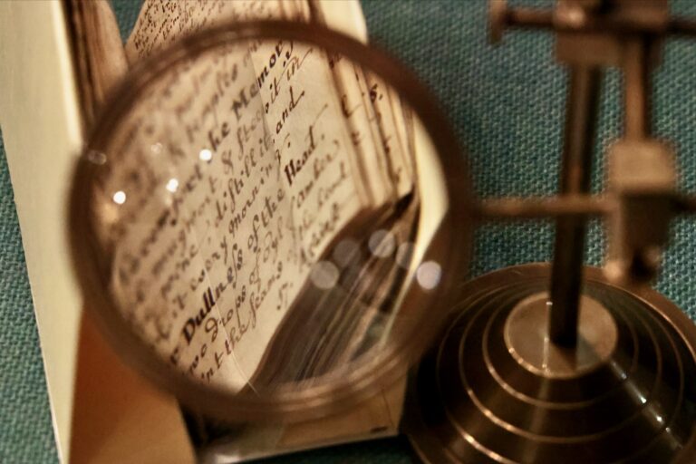 An archival handwritten notebook is on display