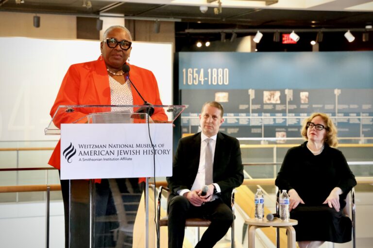 Alida Francis speaks at a podium