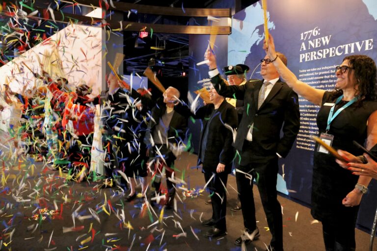 Historians and visiting dignitaries use confetti cannons to celebrate the opening of a new exhibit at the Weitzman National Museum of American Jewish History