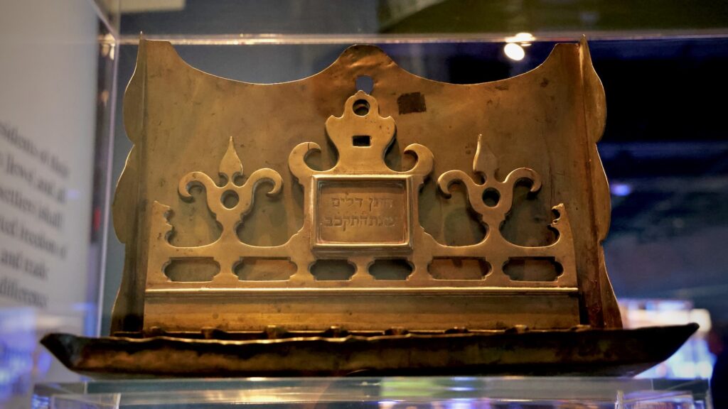 2026 04 22-e lee-philadelphia weitzman museum-the first salute st eustatius hanukkah lamp A Hanukkah lamp from St. Eustatius bears an inscription in Hebrew